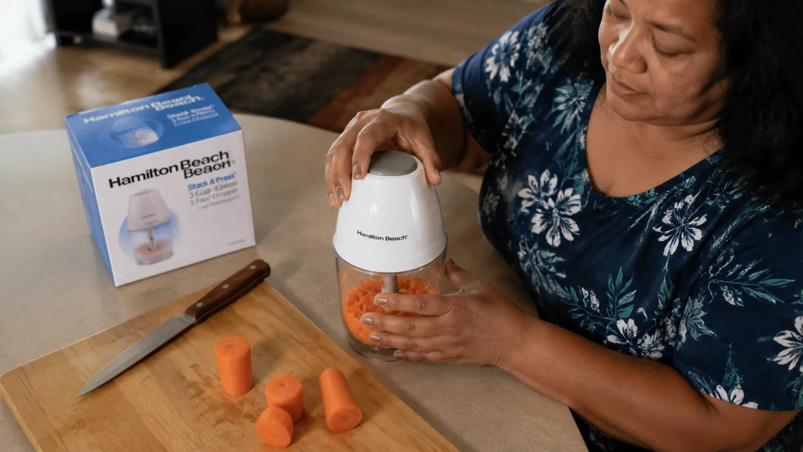 Raw carrot chunks beside the Hamilton Beach food chopper showing the size limits of the 3-cup bowl