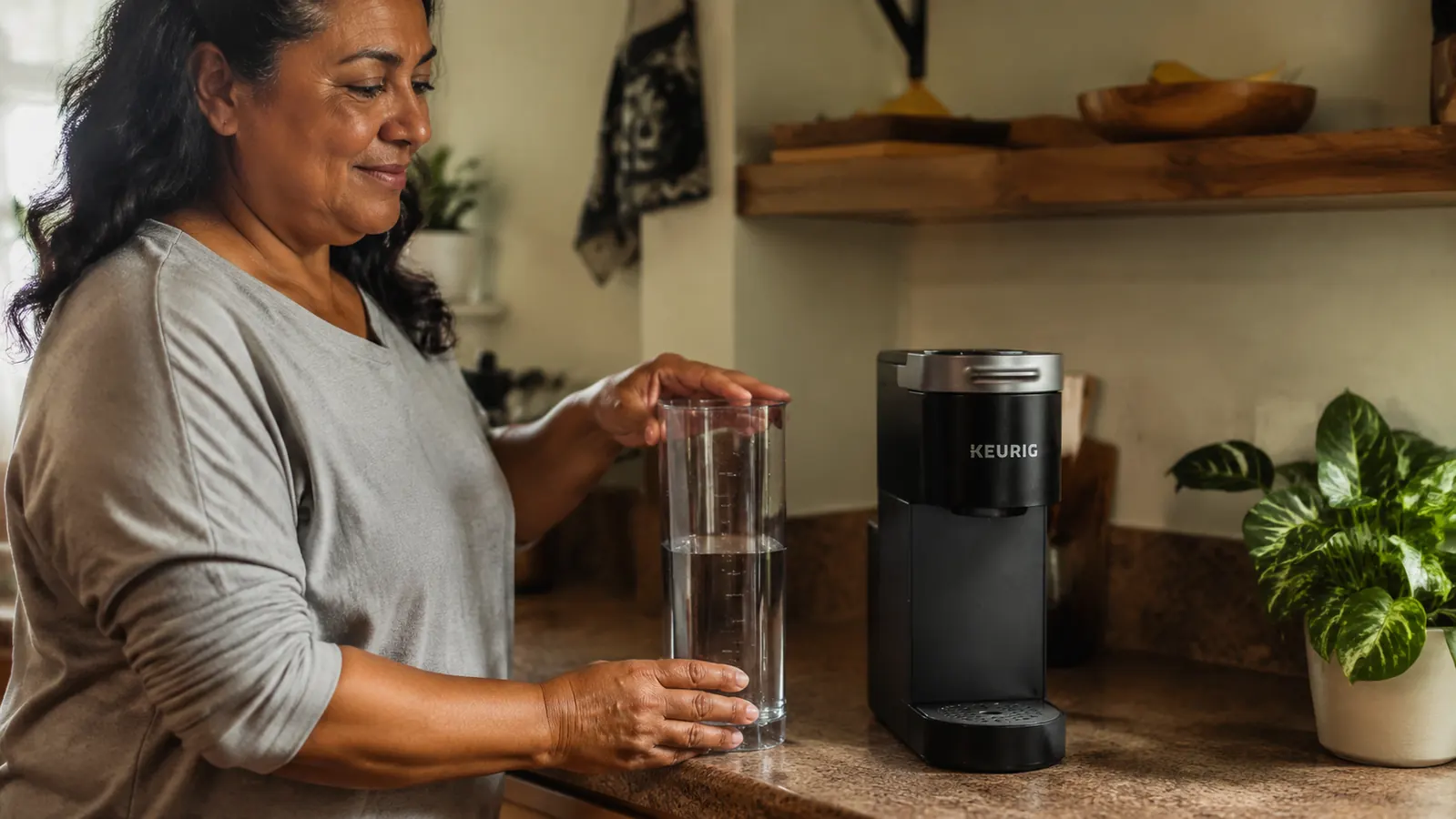 Keurig K-Mini water reservoir removed and sitting beside the machine for easy filling